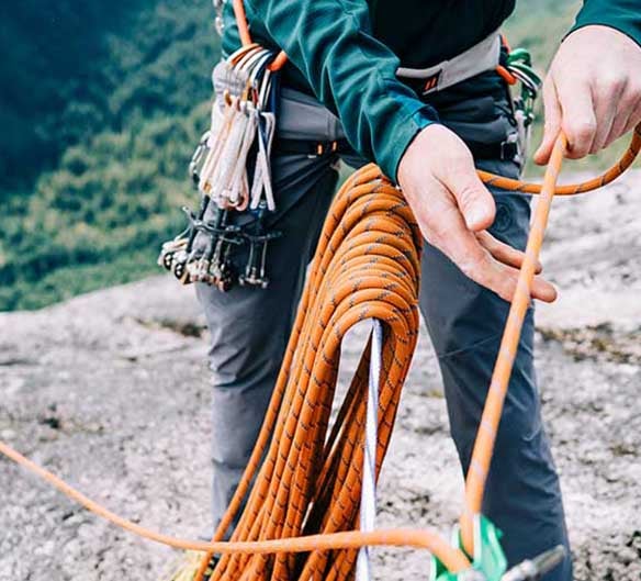 man climbing cliff