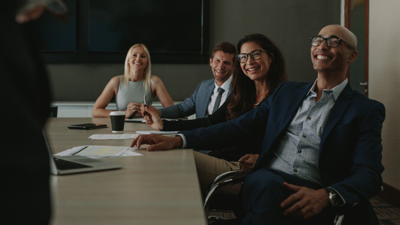 Group of diverse businesspeople smiling during a meeting in conference room. Business people having casual discussion during meeting in board room.