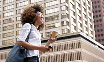 woman walking with coffee