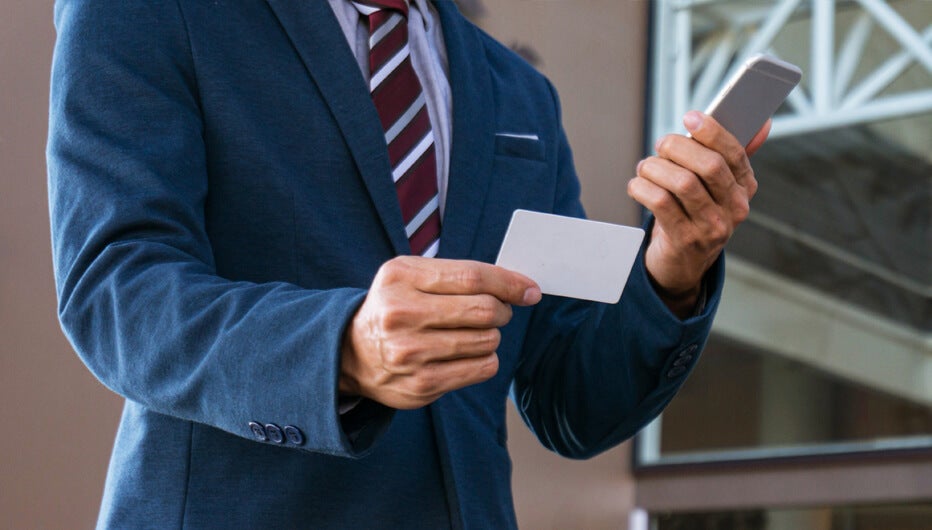 man taking notes from phone