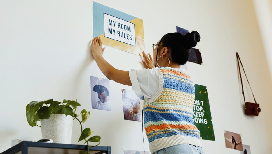 woman hanging sign