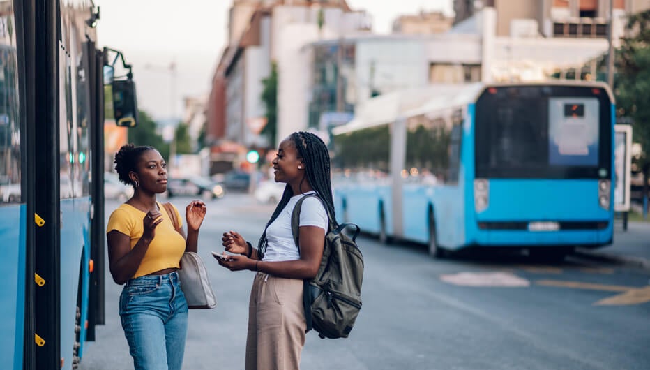 woman talking outside bus