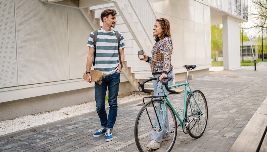 man with skateboard and women with bike