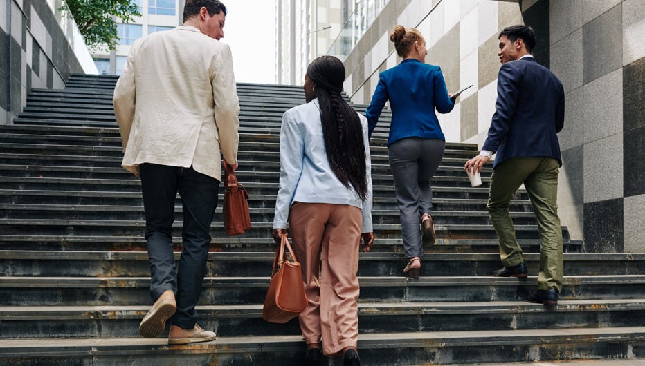 four people walking up stairs