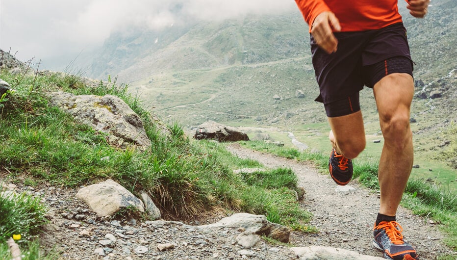 man jogging in mountains