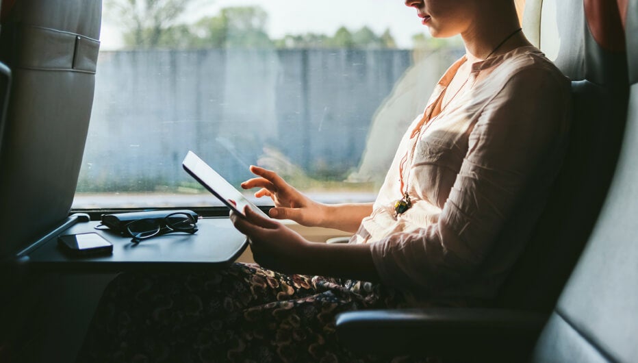 woman using device whilst commuting