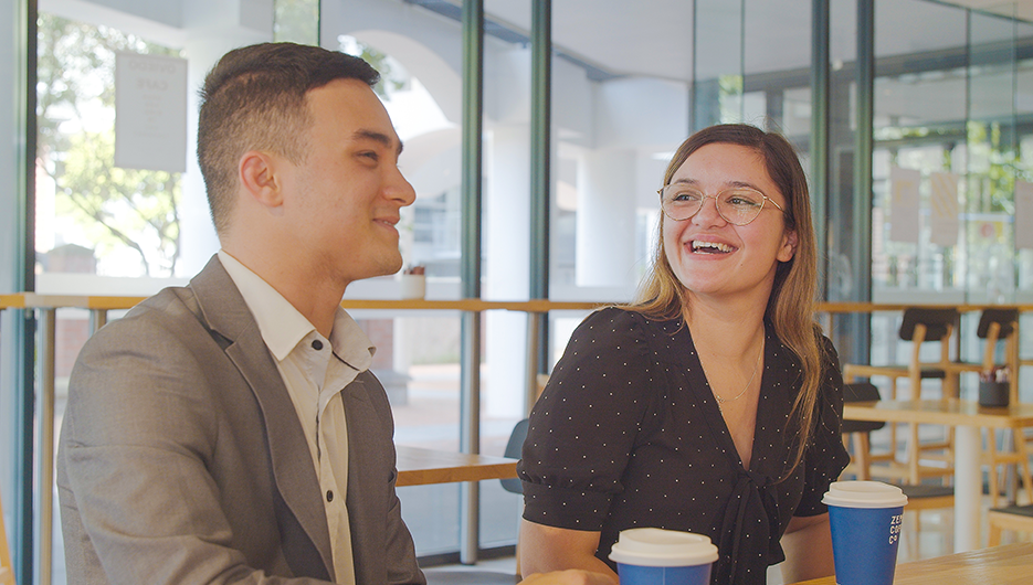 men talking with a woman smiling