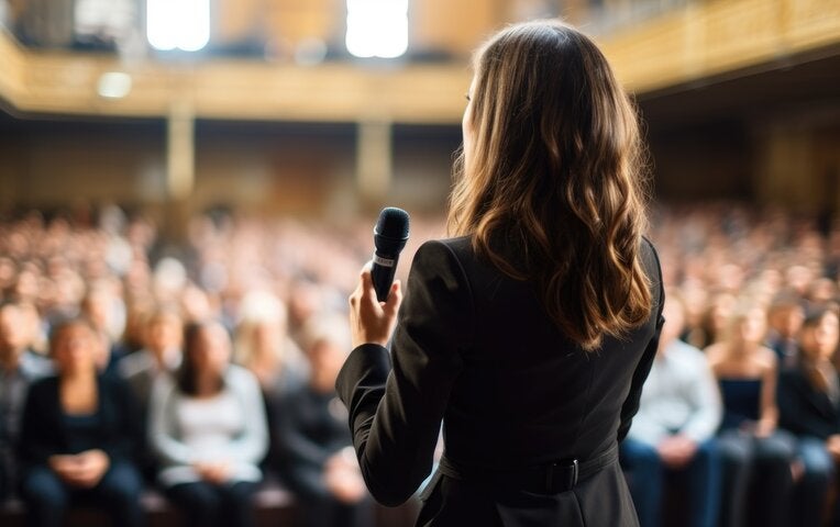 woman speaking in front of public