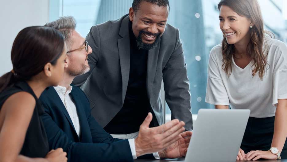 Cropped shot of a group of corporate business colleagues having a meeting around the table in the boardroom.