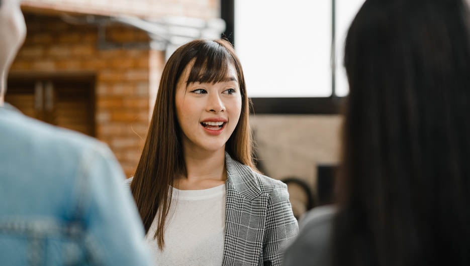 Happy young Asia businessmen and businesswomen meeting brainstorming ideas about new paperwork project colleagues working together planning success strategy enjoy teamwork in small modern office.