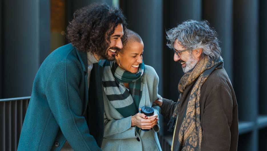 Business people having fun and laughing while talking outdoors on the street. Business, unity and teamwork concept.